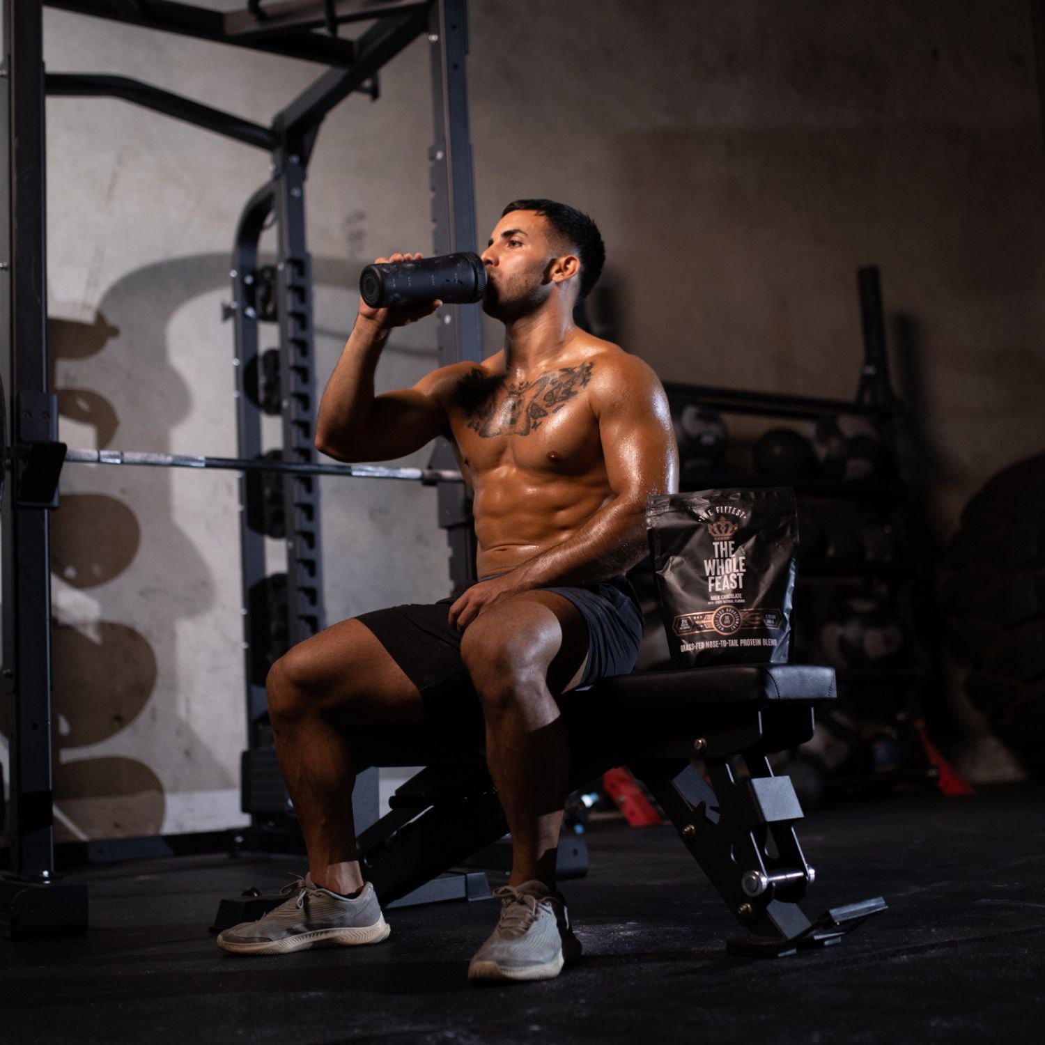 Fit man drinking a post workout shake of whole feast in a gym